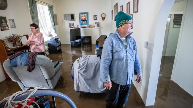 Glenys and Brian Mulcahy in their flooded home on October 14, 2023. Picture: Jason Edwards