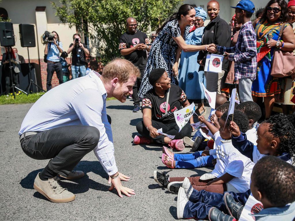 Harry is always a hit with the children. Picture: Betram Malgas/AFP