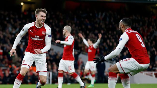 Arsenal's Welsh midfielder Aaron Ramsey (L) celebrates with teammates