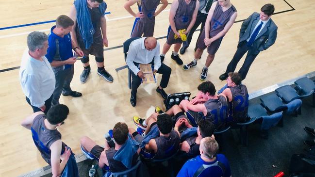 Churchie players listen to coach CJ Bruton in a huddle during the last game against Toowoomba.