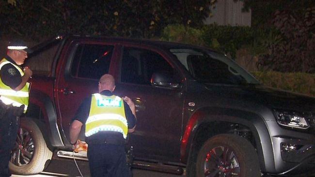 Major Crash officers inspecting the dark grey Amarok V6 W-series ute after the crash Picture: 7 NEWS