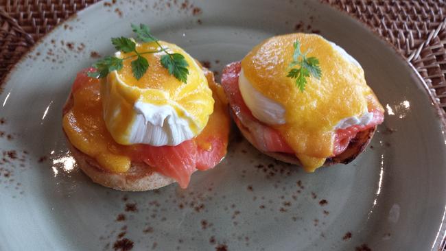 Eggs Benedict with salmon on an English muffin.