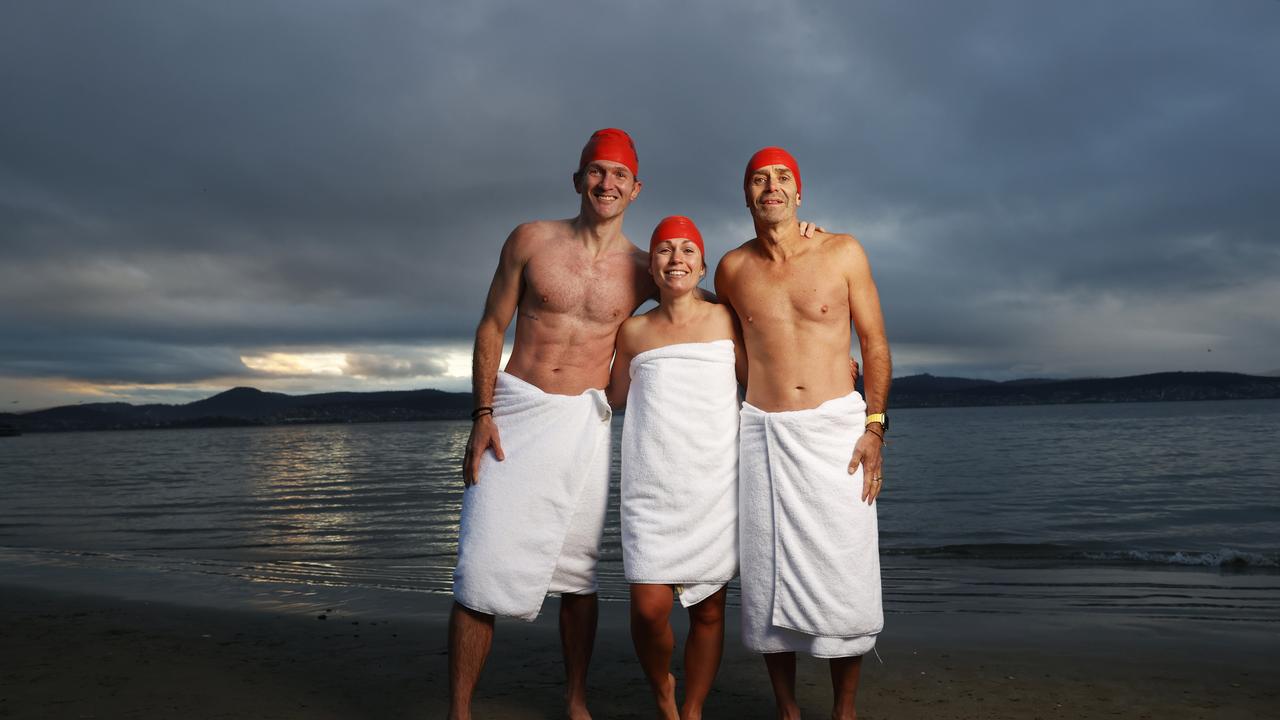 Dave Abrey of Brisbane, Sabrina Carter of Launceston, Glen Harvey of Sydney who became friends after meeting on the beach during the solstice swim one year and now meet up each year to do the swim together. Dark Mofo Nude Solstice Swim 2024 at Long Beach Sandy Bay. Picture: Nikki Davis-Jones