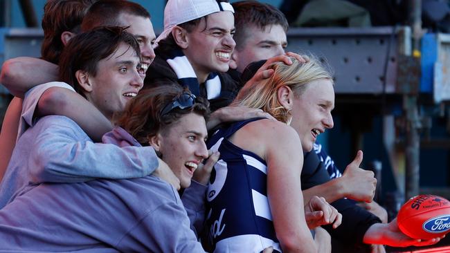 Ollie Dempsey’s mates get around him after his stunning debut with the Cats. Picture: AFL Photos via Getty Images