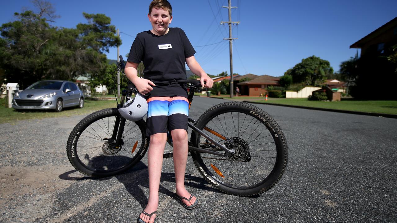 Archie Cross, 13, back on the street in North Haven, NSW, where a week ago he was in his tinny rescuing people from their homes. Picture: Nathan Edwards