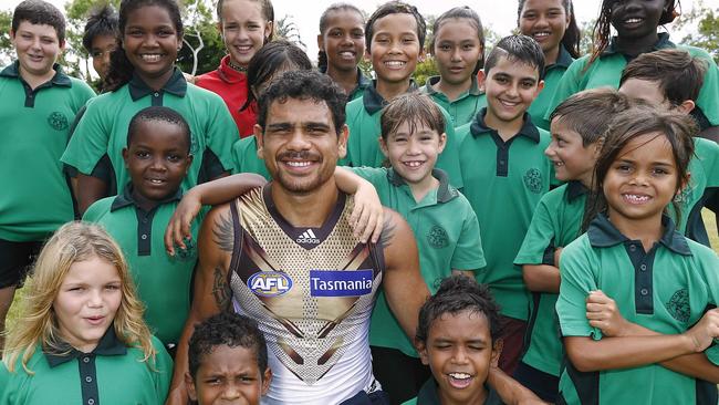 Cyril Rioli road tests Hawthorn’s new clash jumper with schoolchildren in Darwin. Picture: Wayne Ludbey