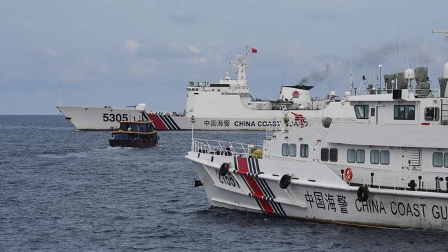 Chinese coast guard ships in August corral a Philippine civilian boat delivering supplies to the Sierra Madre in the disputed South China Sea. Picture: AFP