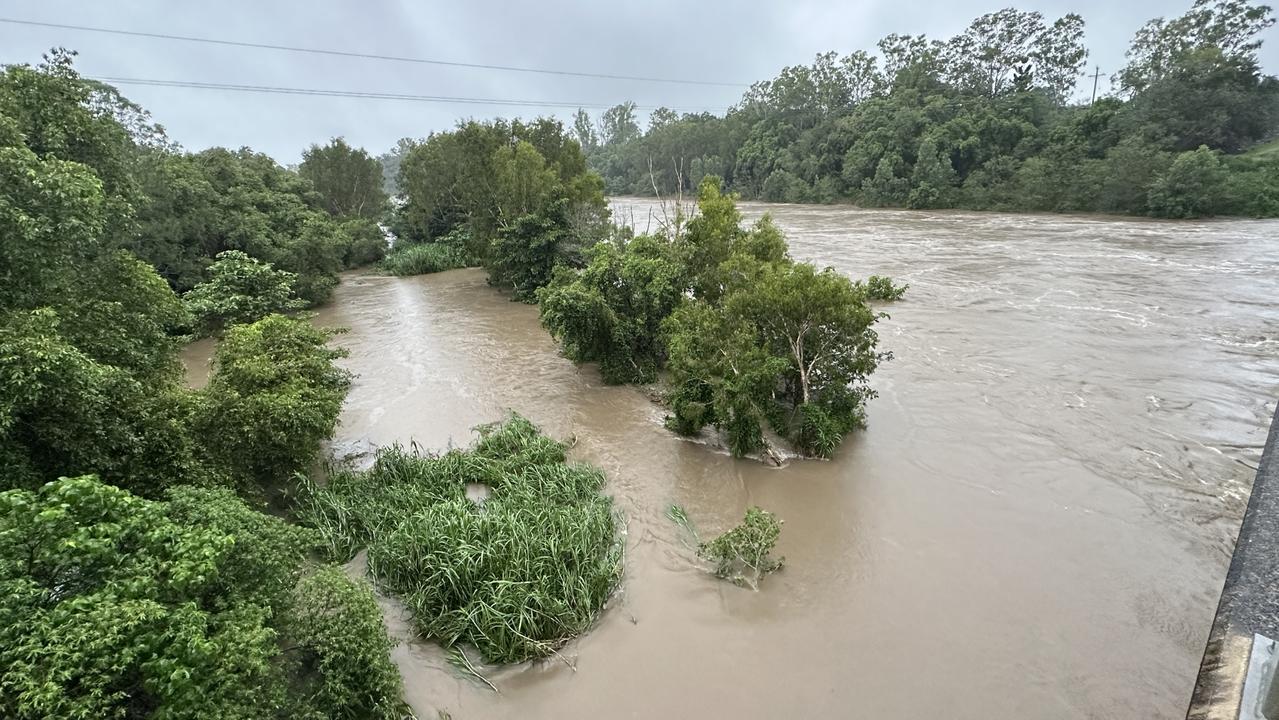 Water was rushing under the Pioneer River bridge at Mirani, west of Mackay, January 16, 2023. Large debris was in the water including two large agricultural tires. Picture: Janessa Ekert