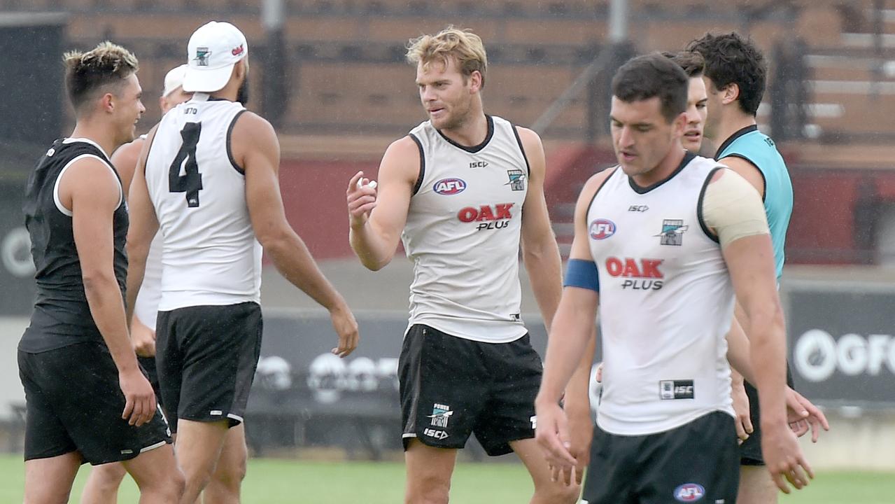 Tom Rockliff takes a breather ahead of Jack Watts at Port Adelaide training at Alberton on Wednesday. Picture: Naomi Jellicoe