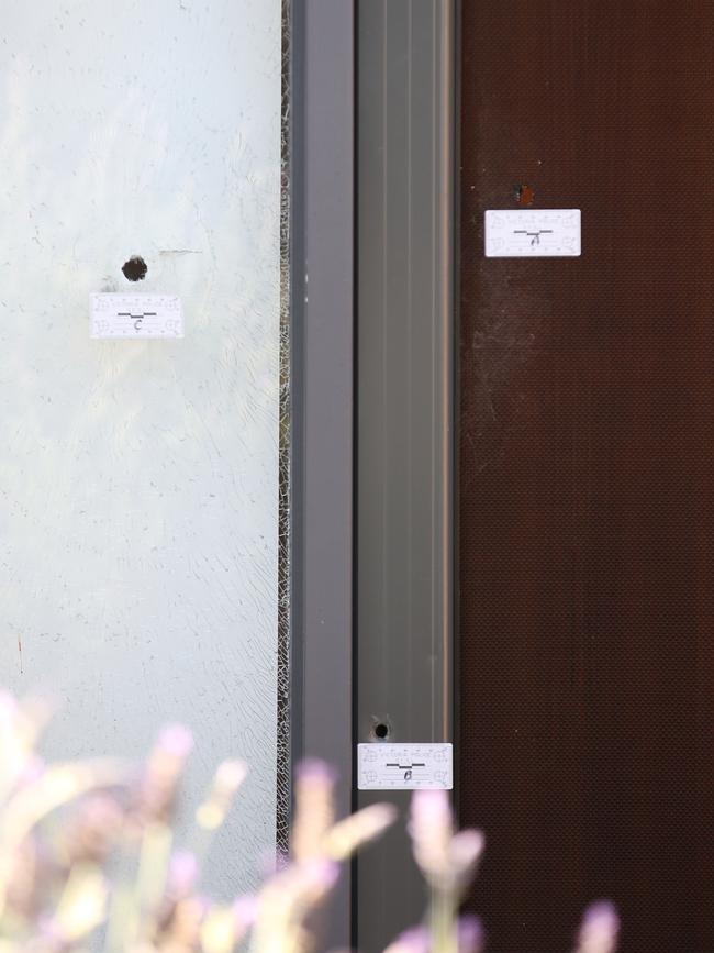 Bullet holes in the front door of Stephen Dank’s home. Picture: David Crosling