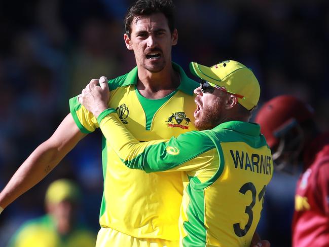 Mitchell Starc with teammate David Warner after taking the wicket of Jason Holder.