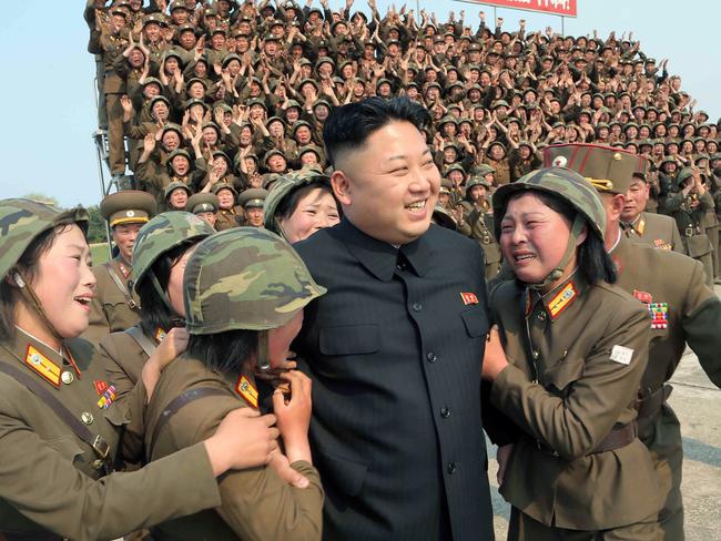 North Korean leader Kim Jong-un smiling with female soldiers. Picture: AFP