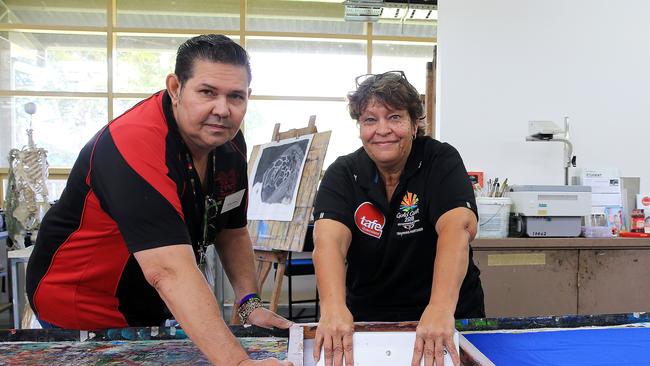 Artist Arone Meeks and fellow TAFE teacher Lynelle Flinders working on art for a fashion show. Picture: Justin Brierty