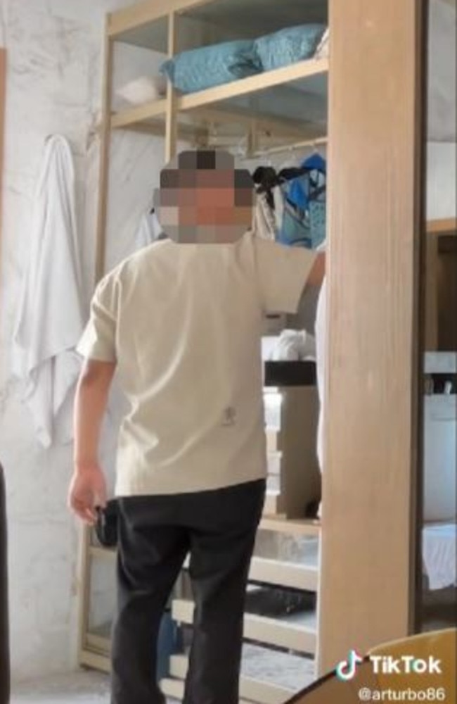 The hotel worker appearing to rummage through the guest’s possessions. Picture: TikTok/arturbo86