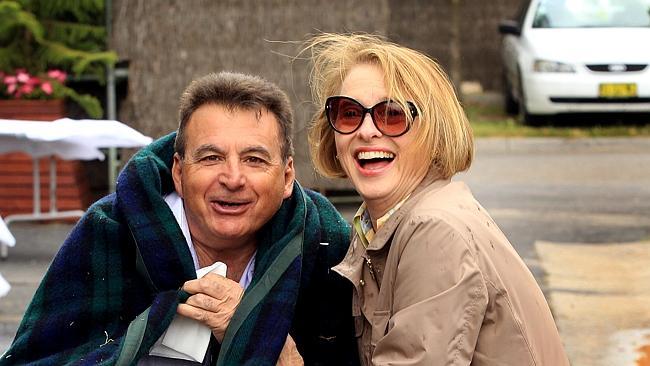 Gai Waterhouse rugs up Phillip Pollicina, a part-owner of Melbourne Cup favourite Fiorente, at her Flemington stables. Picture: 