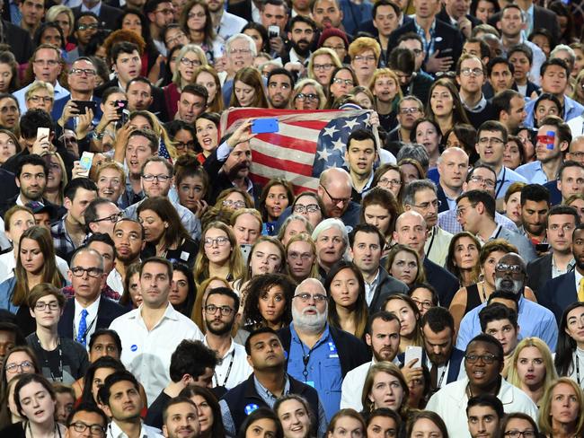 Democratic presidential nominee Hillary Clinton supporters watch the result unfold on a giant screen during election night at the Jacob K. Javits Convention Center in New York on November 8, 2016. Eager voters crowded into polling stations to choose a new US president Tuesday after a wild and bitter contest between the billionaire populist Donald Trump and Hillary Clinton, the Democrat seeking to become the first woman to win the White House. / AFP PHOTO / ANGELA WEISS
