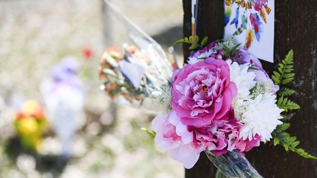 Friends, family and strangers laid flowers near the site.