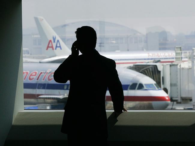 (FILES) In this 27 July 2005 file photo, a man talks on a cell phone in the American Airlines terminal at John F. Kennedy (JFK) International Airport in New York. The FBI is expected to announce 02 June 2007 the arrest of four people in connection with a terror plot against the airport. Media reports say the plot involved a plan to attack jet-fuel pipelines at JFK. Chris Hondros/Getty Images/AFP/FILES =FOR NEWSPAPER, INTERNET, TELCOS AND TELEVISION USE ONLY=ONLY