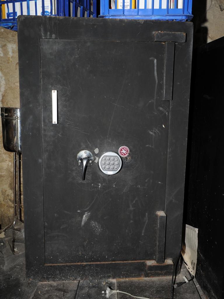 One of three safes located by police, this one in a bedroom contained more than $20,000 cash and an iPhone.