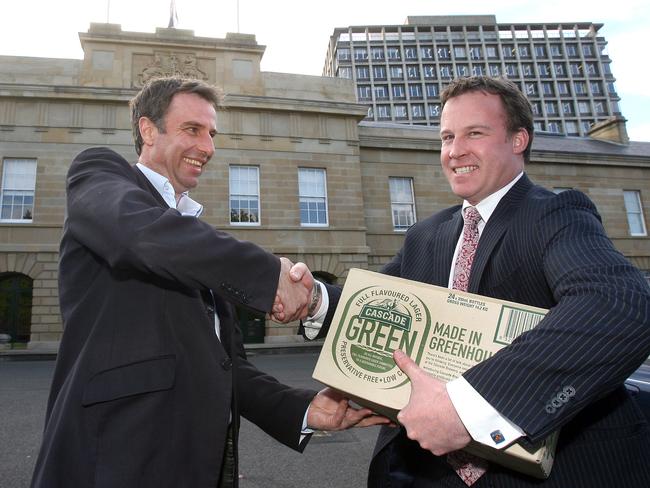 Nick McKim receives his slab from Opposition Leader Will Hodgman after Nicks team Hawthorn won the Grand Final