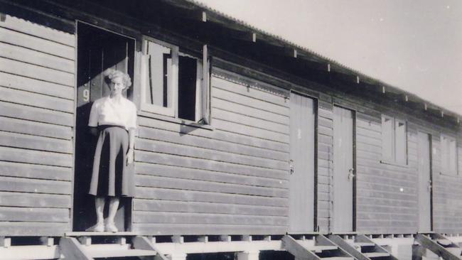 Mrs Magdalena Nydrle, resident and nurse’s assistant at the Stuart Migrant Camp, standing in the doorway of one of the camp buildings’, circa 1951.