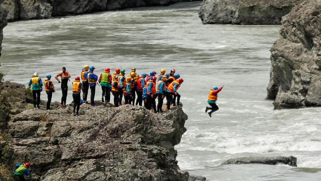 Players jumped from a 10 metre cliff at the end of the rapids to mark the end of the trip. Picture: Michael Willson/AFL Media