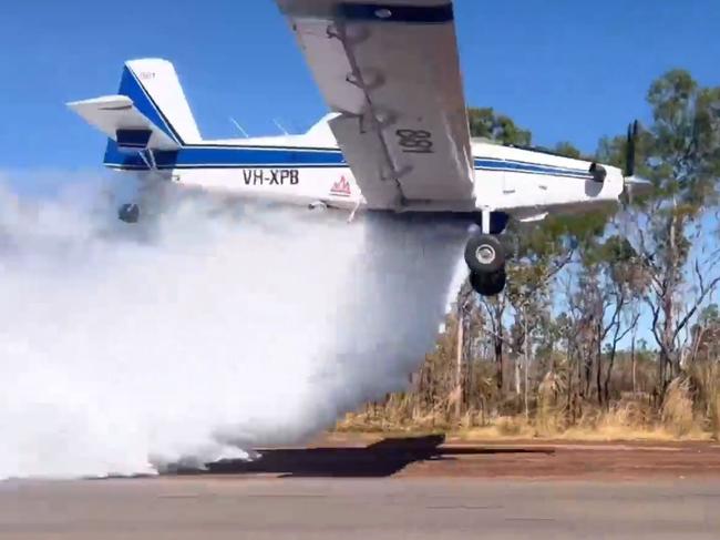 Bushfires NT aircraft conducting a water bombing activity.