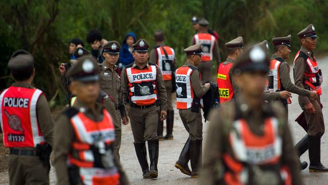 Thai police guard a road leading to the Tham Luang cave area. Picture: AFP.