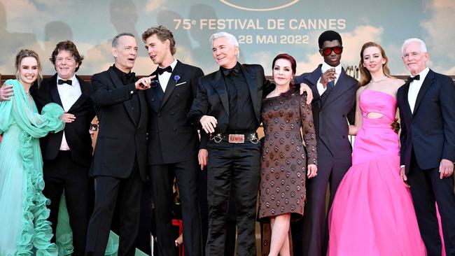 Baz Luhrmann and Priscilla Presley, centre, in Cannes with the Elvis cast, including Tom Hanks and rising star Austin Butler, left of Luhrmann, and Aussie Olivia DeJonge, far left. Picture: AFP