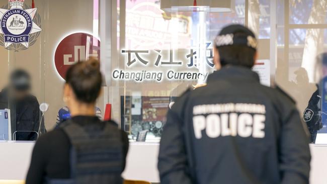 Police executing a search warrant at Changjiang Currency Exchange in Sydney as part of Operation Avarus-Nightwolf.