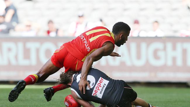 Touk Miller of the Suns cleans up Jack Steven of the Saints 4th qtr. Pic: Michael Klein.