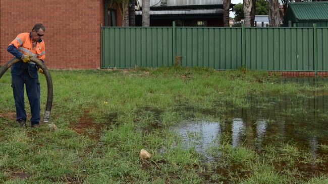 An SA Water employee at Avenue Road, Paradise, where a water pipe has burst again. Pic: Tricia Watkinson