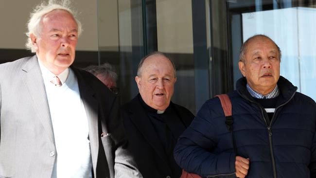 Philip Wilson, centre, leaves court with supporters Wally Armstrong, left, and John Wong, right. Picture: Peter Lorimer / AFP