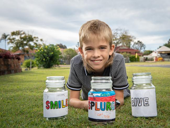 Darcy Fletcher uses three jam jars to save and manage his money. Picture: Brad Fleet