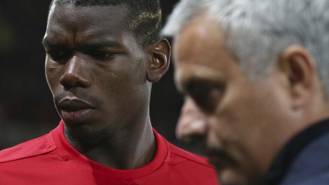 FILE - In this Thursday, Sept. 29, 2016 file photo Manchester United's manager Jose Mourinho, right, with Manchester United's Paul Pogba just prior to the start of Europa League group A soccer match between Manchester United and Zorya Luhansk at Old Trafford, Manchester, England. Manchester United says Jose Mourinho has left the Premier League club with immediate effect. The decision was announced Tuesday Dec.18, 2018, two days after a 3-1 loss to Liverpool left United 19 points off the top of the Premier League after 17 games. (AP Photo/Dave Thompson, File)