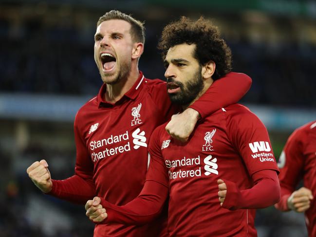 BRIGHTON, ENGLAND - JANUARY 12:  Mohamed Salah of Liverpool celebrates with team mate Jordan Henderason of Liverpool after scoring their first goal from the penalty spot during the Premier League match between Brighton & Hove Albion and Liverpool FC at American Express Community Stadium on January 12, 2019 in Brighton, United Kingdom.  (Photo by Bryn Lennon/Getty Images)