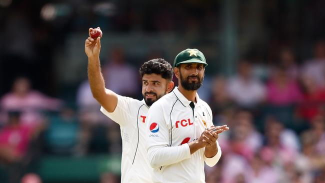 Aamer Jamal holds the ball aloft to the crowd after taking his fifth wicket. Picture: Getty