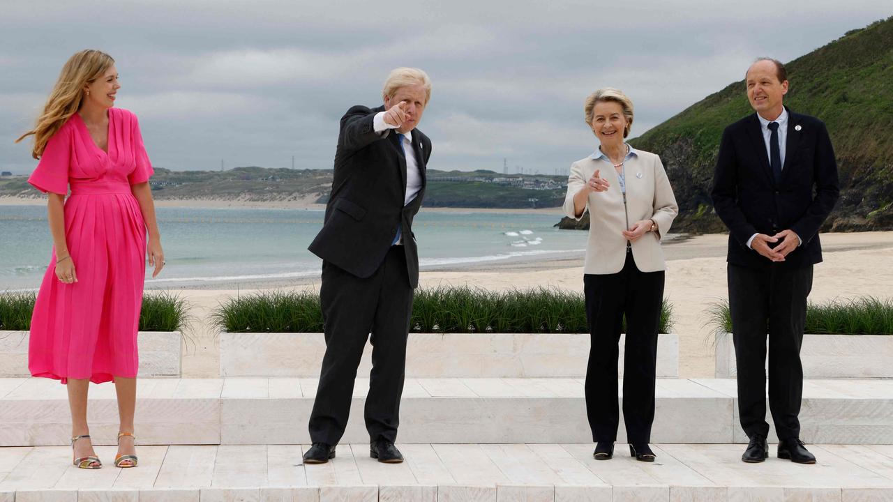 Boris appears to be showing European Commission President Ursula von der Leyen and her husband Heiko Echter von der Leyen where the camera is. Heiko is still looking in the wrong direction, however. Picture: Ludovic Marin/AFP