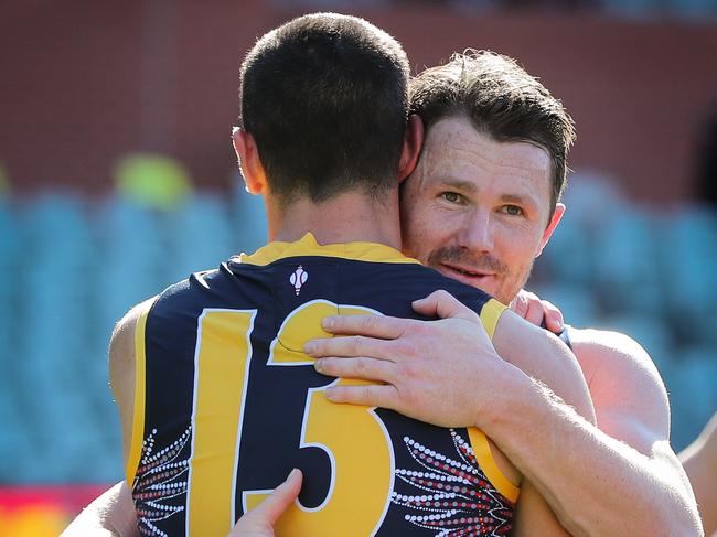 Taylor Walker embraces Patrick Dangerfield after his 200th. (Photo by Matt Turner/AFL Photos via Getty Images)