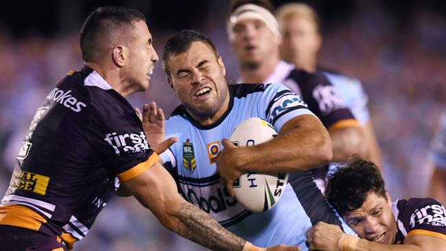 Wade Graham tries to break through the Broncos defence.