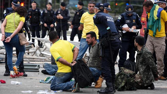 Security forces arrest supporters of Brazilian former President Jair Bolsonaro after retaking control of Planalto Presidential Palace in Brasilia on Sunday, local time. Picture: AFP