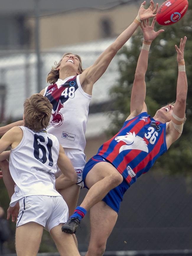 Josh Worrell spoils the attempted mark by Oakleigh’s Charlie Beasley. Picture: Andy Brownbill