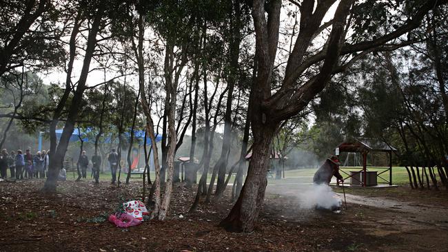 A smoking ceremony was held during a vigil for Nicole Cartwright at Buffalo Creek Reserve Playground. Picture: Adam Yip