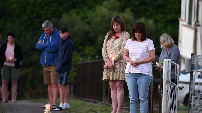 People stand outside their homes at dawn to commemorate Anzac Day in Brisbane, Saturday, April 25, 2019. Anzac Day is a national day of remembrance to commemorate the service and sacrifice of Australian and New Zealand service men and women. Due to COVID-19 restrictions marches and commemorative services have been banned for the first time in more than a century. (AAP Image/Dan Peled) NO ARCHIVING