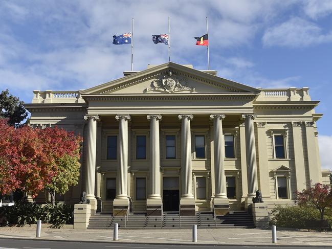 Flags flying half mast at City Hall. Marchers took part in an Anzac Parade through Malop Street to Johnstone Park on Anzac Day. Crowds lined the street but there were none of the usual formalities at the finale. Picture: Alan Barber