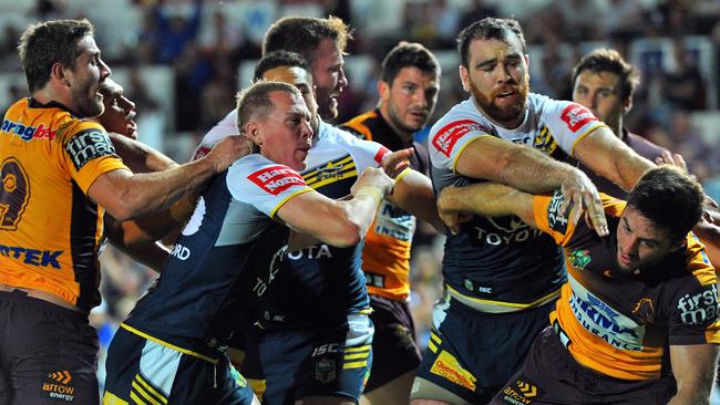 Cowboys and Broncos players push and shove.