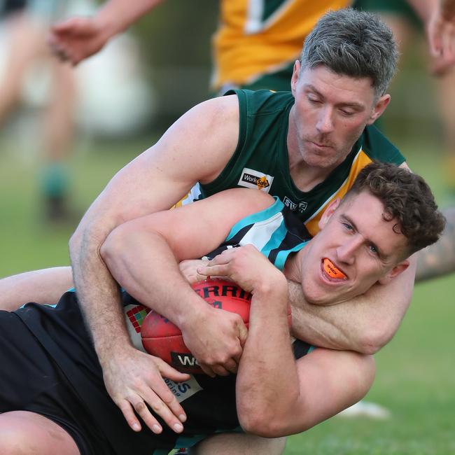 Murchison-Toolamba’s Adam Macgibbon tackles Dookie United’s Henry Cook high.