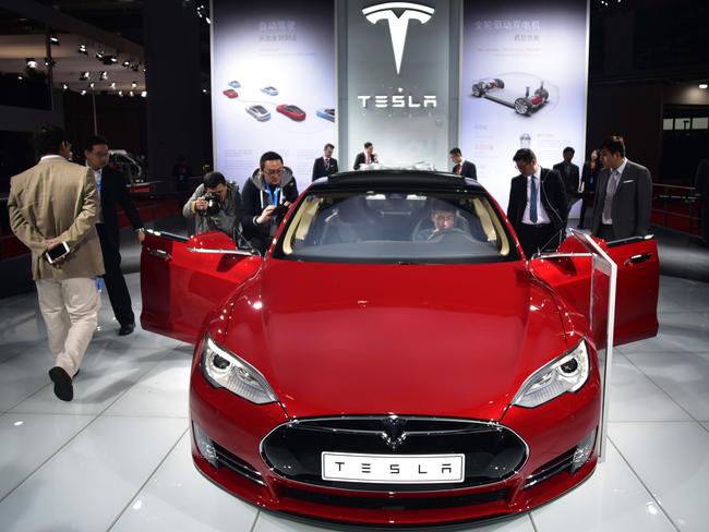 This April 20, 2015 file photo shows a Tesla Model S P85d car displayed at the 16th Shanghai International Automobile Industry Exhibition in Shanghai.  Global carmakers converge on China for the Shanghai auto show this week with the industry bracing for a sharp sales slowdown and potential price war as competition stiffens in the world's biggest car market. / AFP PHOTO / JOHANNES EISELE / TO GO WITH AFP STORY:  China-auto-show-automobile, ADVANCER by Dan Martin