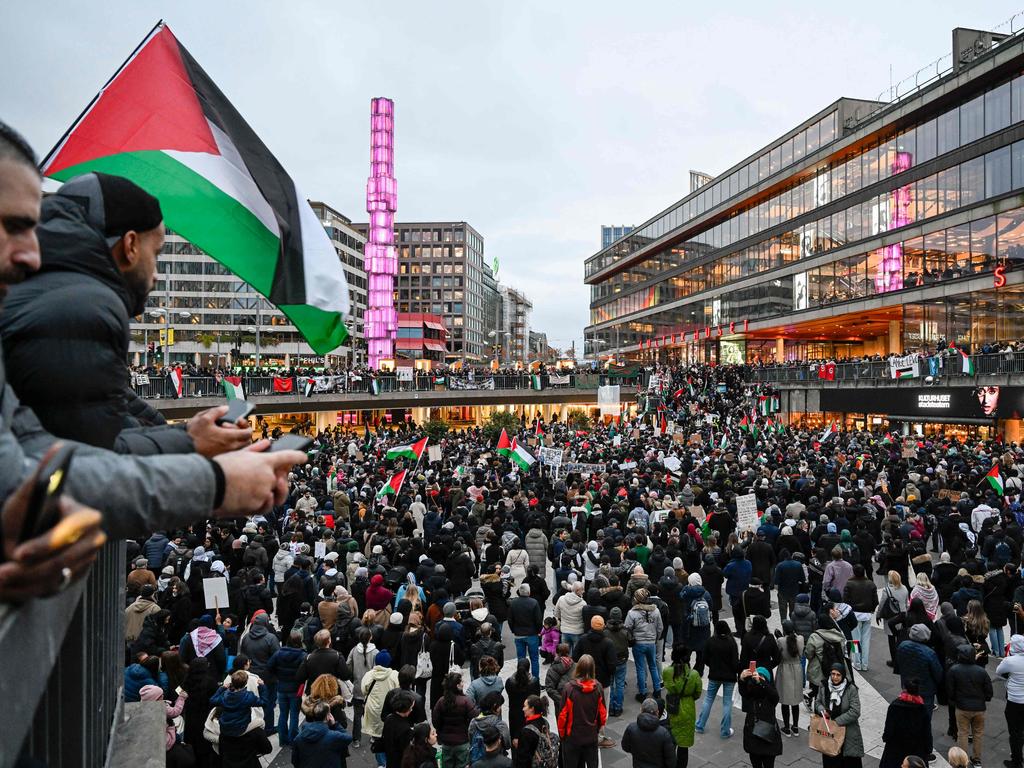 Demonstrators wave flags and display placards during a demonstration in solidarity with Palestinians in the Gaza Strip, at Sergel's Square in Stockholm. Picture: AFP