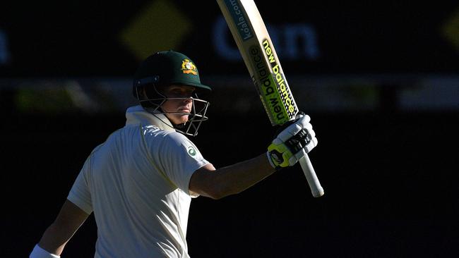 Steve Smith celebrates as he reaches his half century on the second day of the first Ashes Test. Picture: AFP